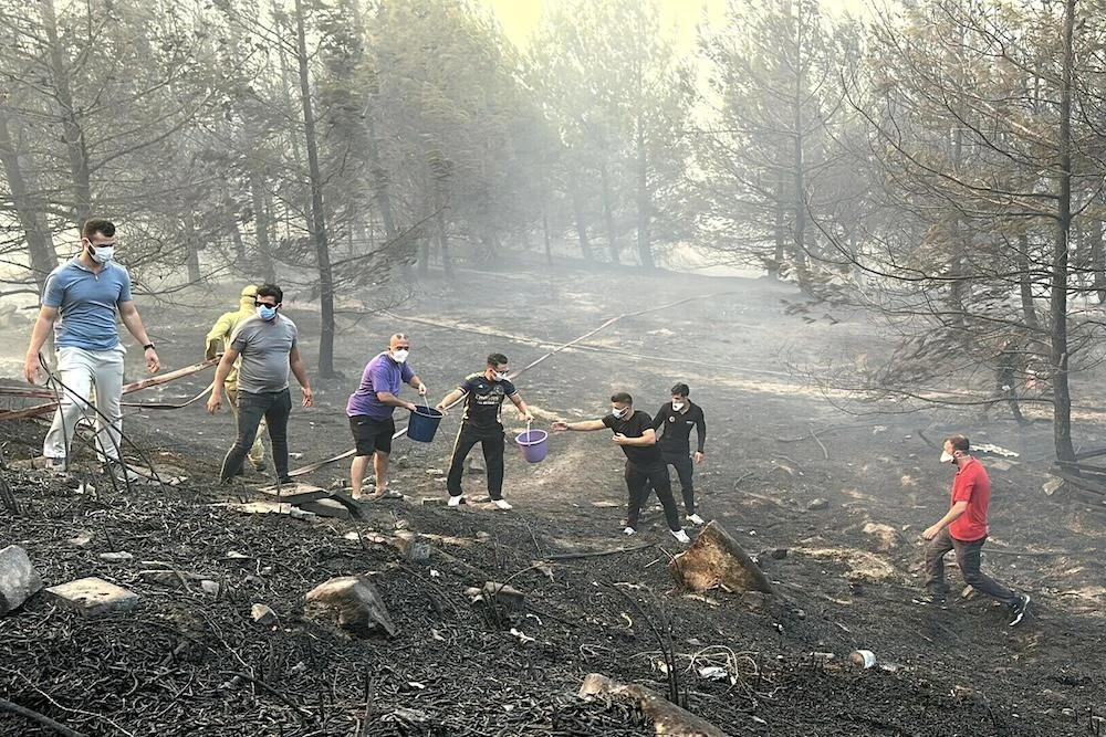 Residents work to extinguish wildfire in Canakkale, northwestern Turkey in the Marmara region on Aug. 8, 2025. (Demiroren News Agency/AFP)