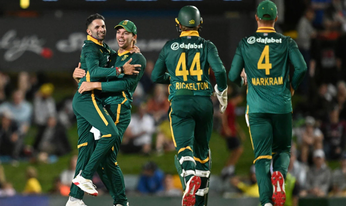 Keshav Maharaj, left, of South Africa is congratulated by a teammate after getting the wicket of Cameron Green of Australia during the one day international between Australia and South Africa. (AP)
