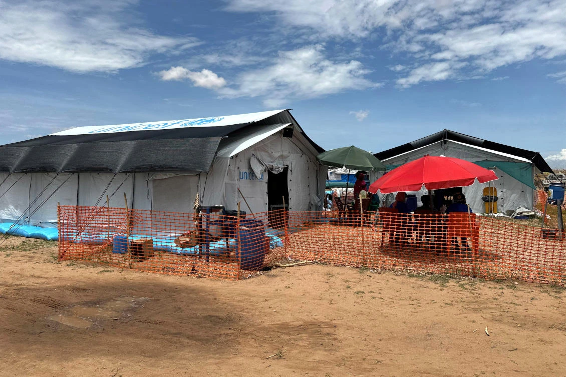 People sit outside the cholera isolation centre in at the refugee camps of western Sudan, in Tawila city in Darfur, on August 14, 2025. (File/AFP)