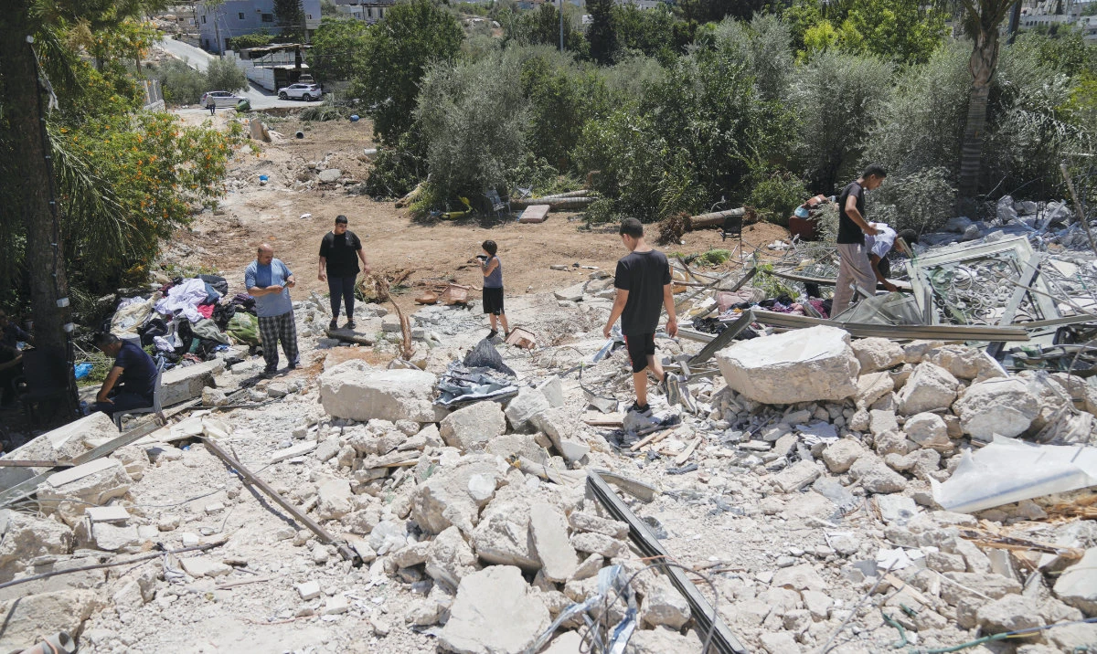 Palestinians check the rubble of a house after it was demolished by the Israeli army in the West Bank village of Beit Sira, near Ramallah. (AP)