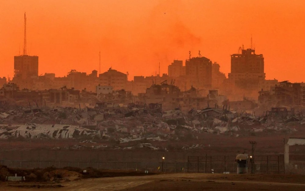 Destroyed buildings in Gaza are visible, as the sun sets, from Israel, Aug. 21, 2025. (AFP)