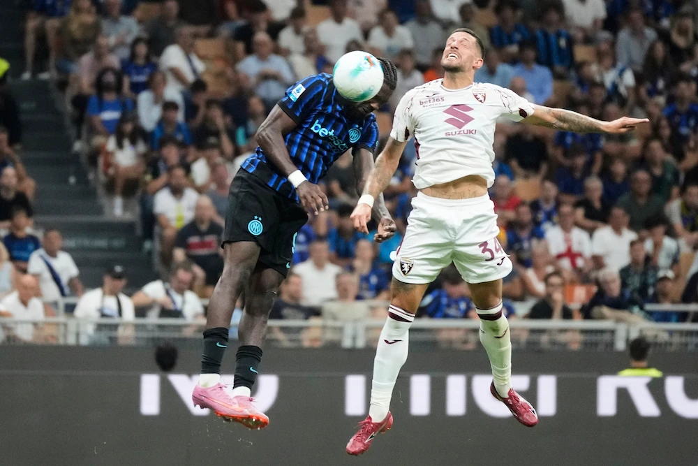 Inter Milan’s Marcus Thuram, left, scores his side’s 4th goal past Torino’s Cristiano Biraghi during a Serie A match between Inter Milan and Torino, at the San Siro stadium in Milan Monday. (AP)