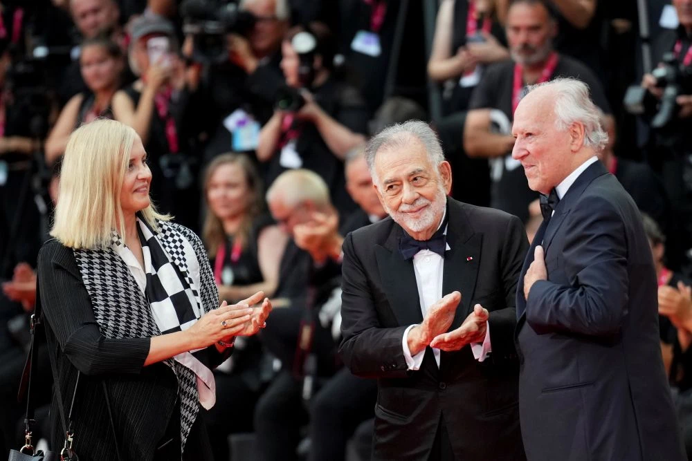 Lena Herzog, Francis Ford Coppola and Werner Herzog pose for photographers on the red carpet at the 82nd edition of the Venice Film Festival in Venice, Italy, Wednesday, Aug. 27, 2025. (AP Photo)