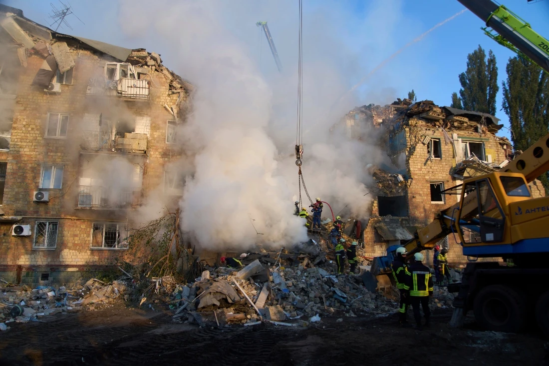 Firefighters extinguish fire in a building after a Russian missile attack in Kyiv, Ukraine. (AP)