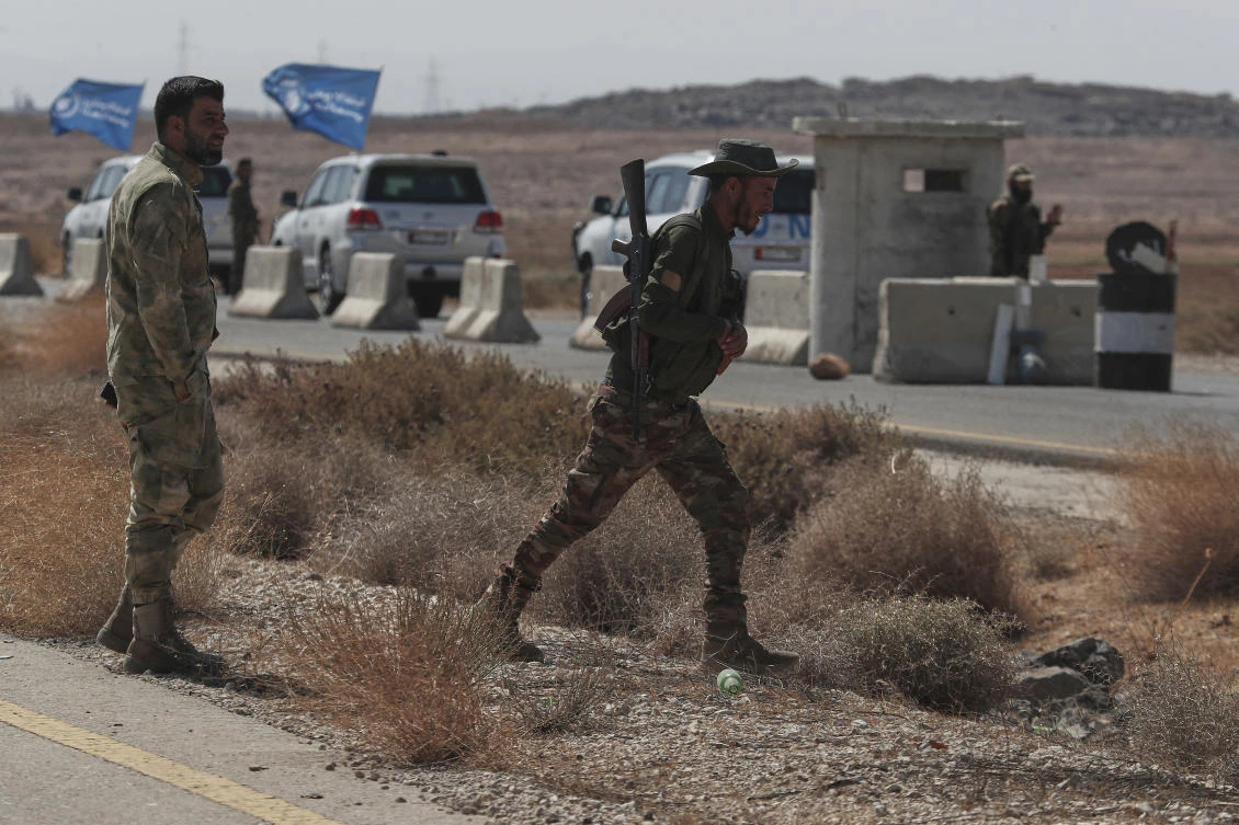 A convoy of U.N. vehicles crosses a Syrian government forces checkpoint, heading to Sweida city southern Syria, Thursday, Aug. 28, 2025, to distribute humanitarian aid. (AP)