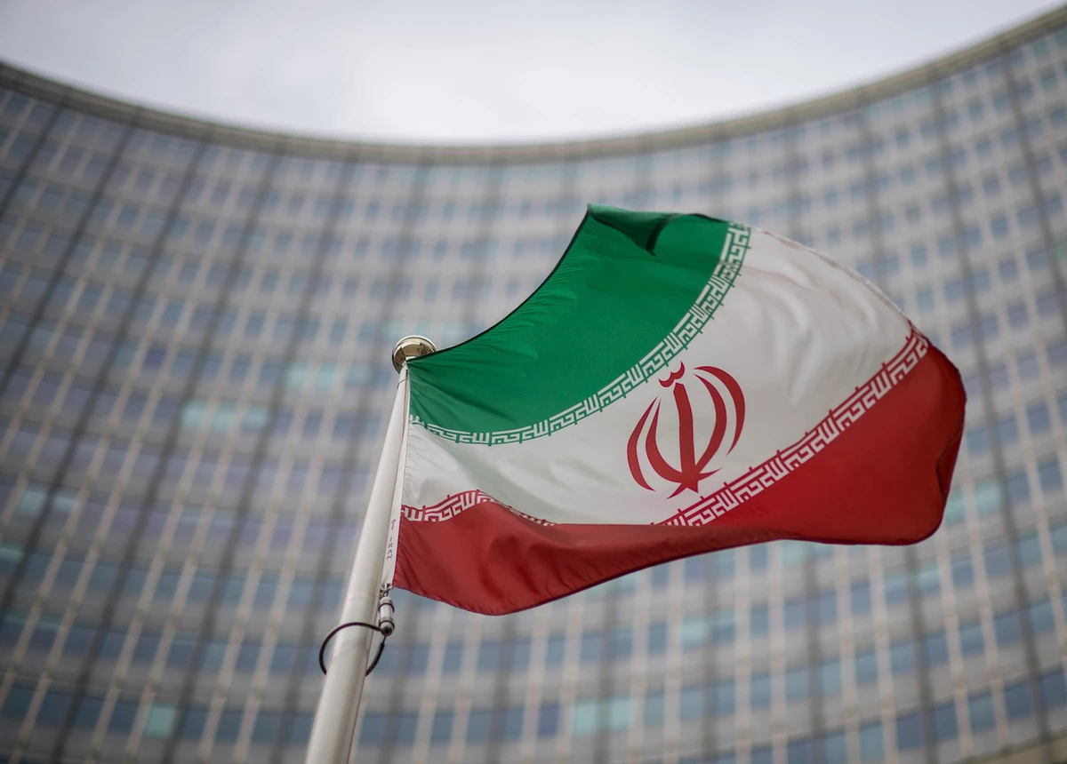 A national flag of Iran waves in front of the building of the International Atomic Energy Agency, IAEA, in Vienna, Austria. (AP)
