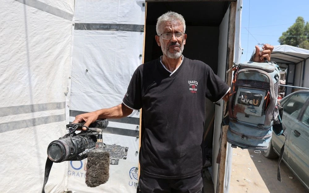 Ezzeldin Al-Masri holds equipment used by his brother Hussam Al-Masri, who was killed by an Israeli strike on Gaza’s Nasser Hospital, in Khan Younis, southern Gaza Strip, Aug. 26, 2025. (Reuters)