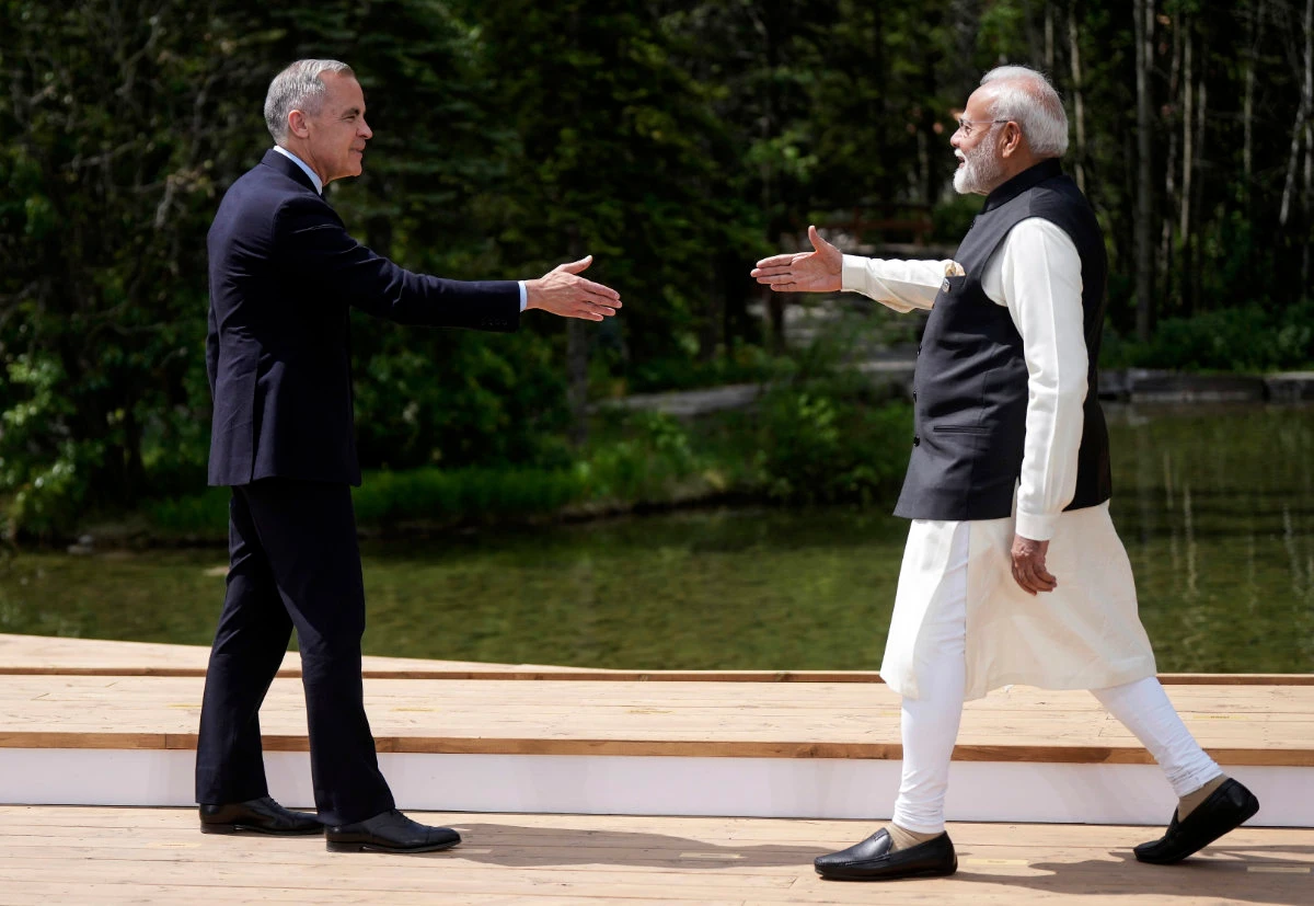 Canada's Prime Minister Mark Carney, left, and India's Prime Minister Narendra Modi reach to shake hands as Carney officially welcomes him to the G7 Summit in Kananaskis, Alberta, on June 17, 2025. (The Canadian Press via AP, File)