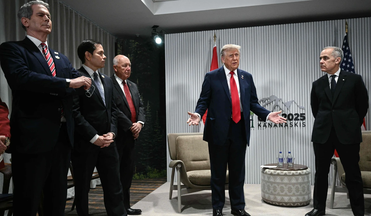 President Trump speaks as Canadian PM Mark Carney (R) looks on as they meet during the G7 Summit in Alberta. (AFP)