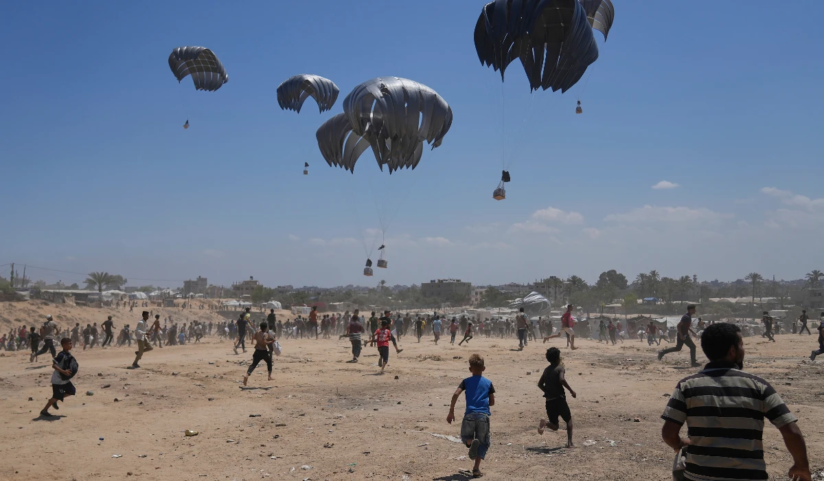 Palestinians rush to collect humanitarian aid airdropped by parachutes into Zawaida in Gaza, Monday, Aug. 4, 2025. (AP)