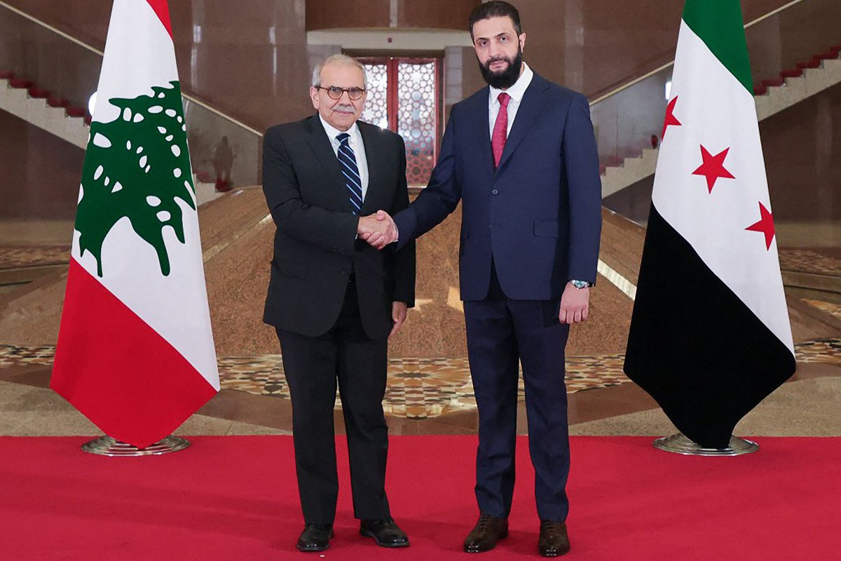 Syria’s interim President Ahmed al-Sharaa shaking hands with Lebanon’s Prime Minister Nawaf Salam during their meeting in Damascus, April 14, 2025. (File/AFP)
