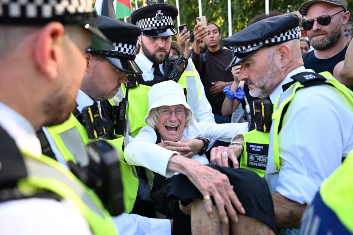 Police officers arrest an 89-year-old protester at a demonstration in support of Palestine Action in Parliament Square, central London. (File/AFP)