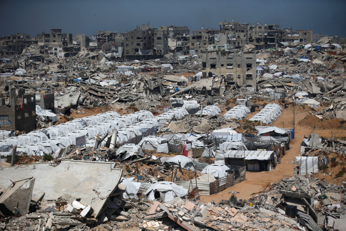 Palestinians displaced by the Israeli military offensive, shelter in tents near the rubble of houses in Jabalia refugee camp, in the northern Gaza Strip, May 8, 2025. (REUTERS)