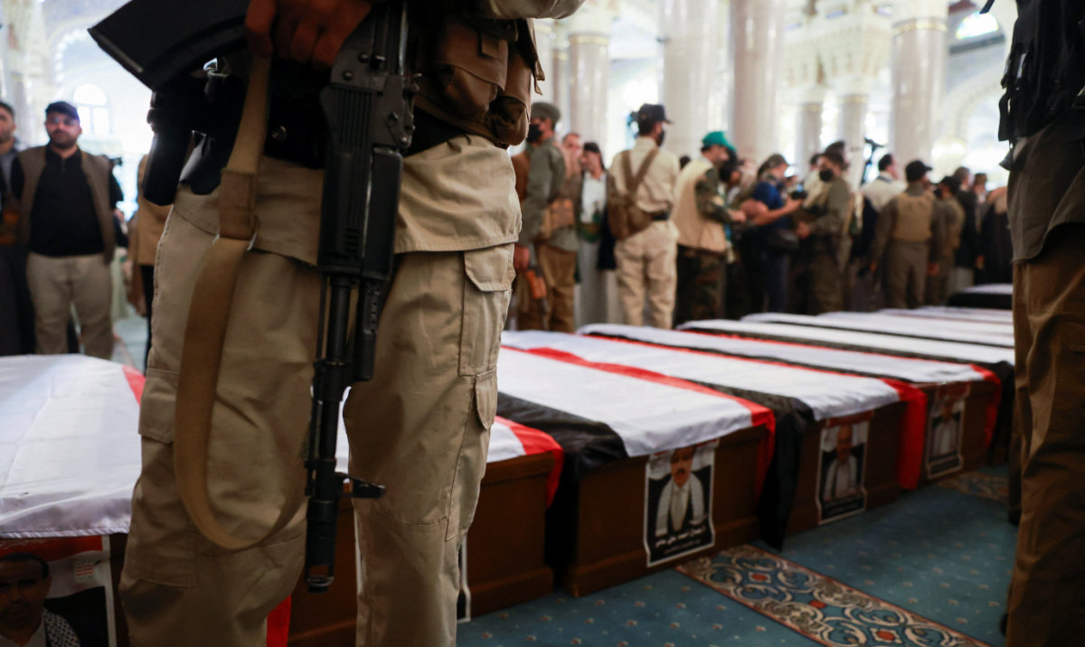 A member of the Houthi stands guard next to the coffins of Houthi government officials killed in an Israeli strike, during the funeral procession in Sanaa, Yemen September 1, 2025. (Reuters)