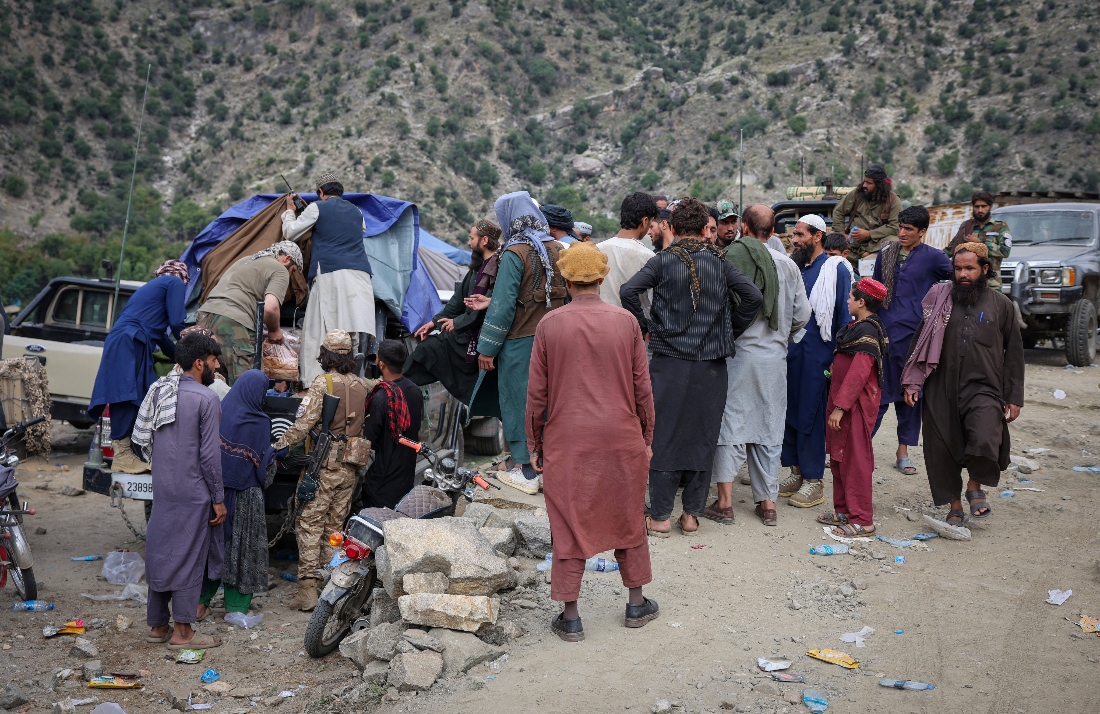 Members of Taliban distribute food to the victims of a deadly magnitude-6 earthquake that struck Afghanistan, in Mazar Dara, Kunar province, Afghanistan. (Reuters)