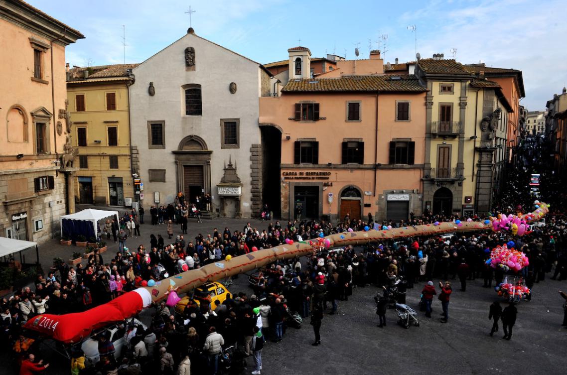 People dressed as the witch Befana carry a 54-metre long stocking during the annual Befana procession in Viterbo on January 12, 2014. (FILE/AFP)
