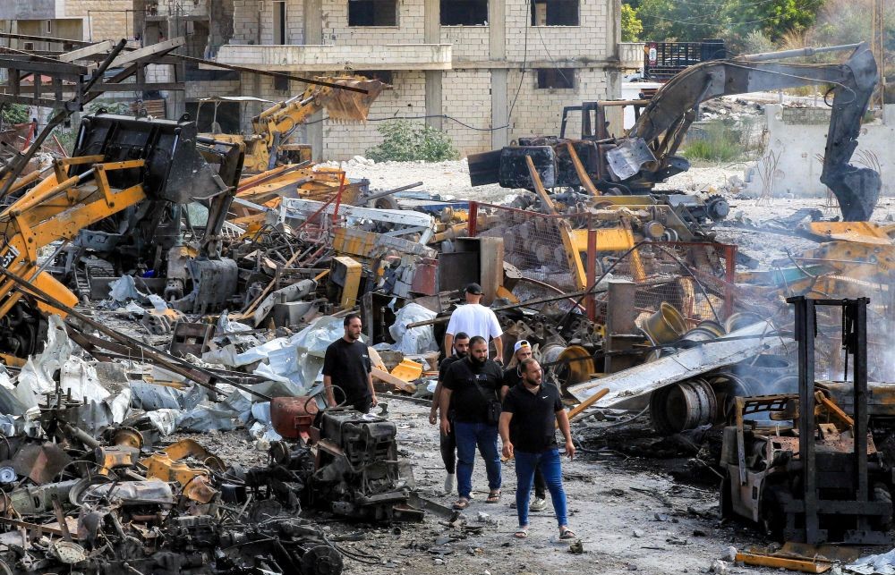 People inspect damaged bulldozers, excavators, and other vehicles in the aftermath of overnight Israeli airstrikes on an industrial complex, Ansariyah, southern Lebanon, Sept. 4, 2025. (AFP)