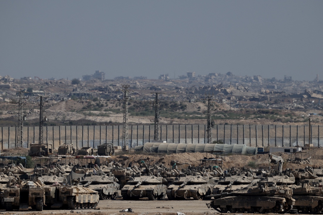 Military vehicles stand on the Israeli side of the border with Gaza. (Reuters)