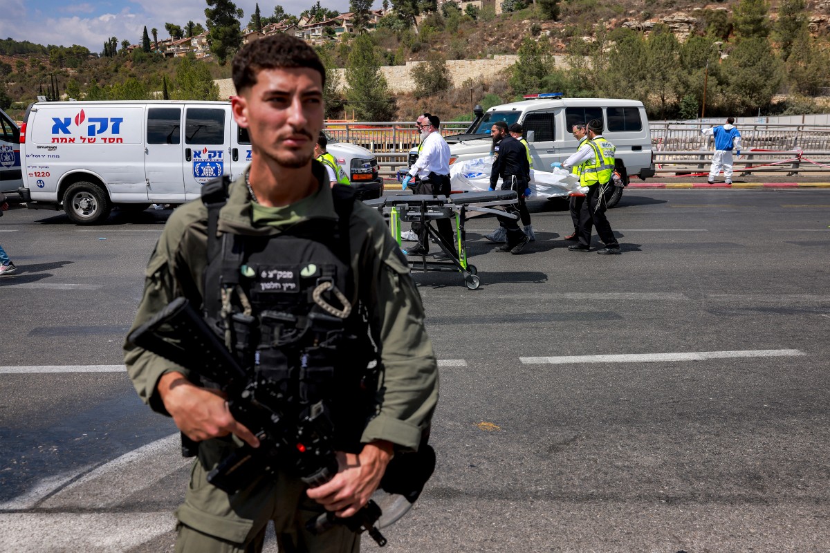 Members of Israel's ZAKA search and rescue emergency services transport a body from the scene of a shooting at the Ramot road junction in Israeli-annexed east Jerusalem on September 8, 2025. (AFP)