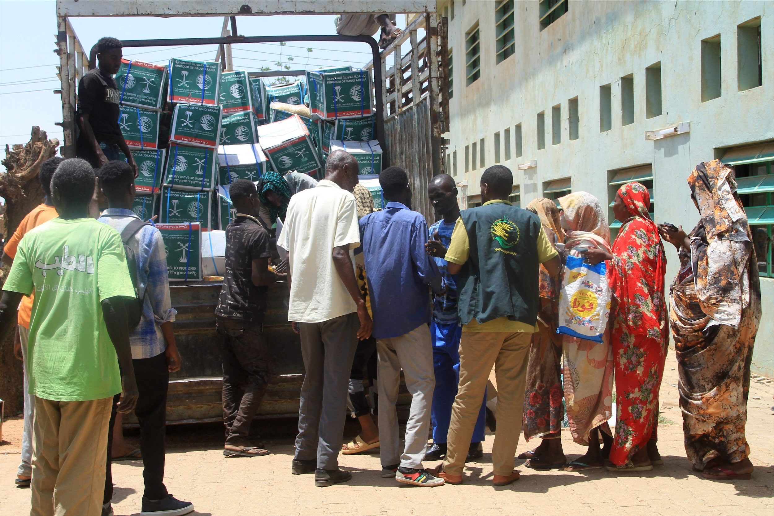 Sudanese queue to receive aid in Khartoum on Monday. (AFP)