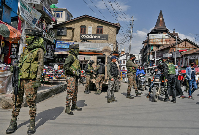 Paramilitary troopers stand guard during a random search operation at a market area in Srinagar on April 22, 2022. (AFP/File)