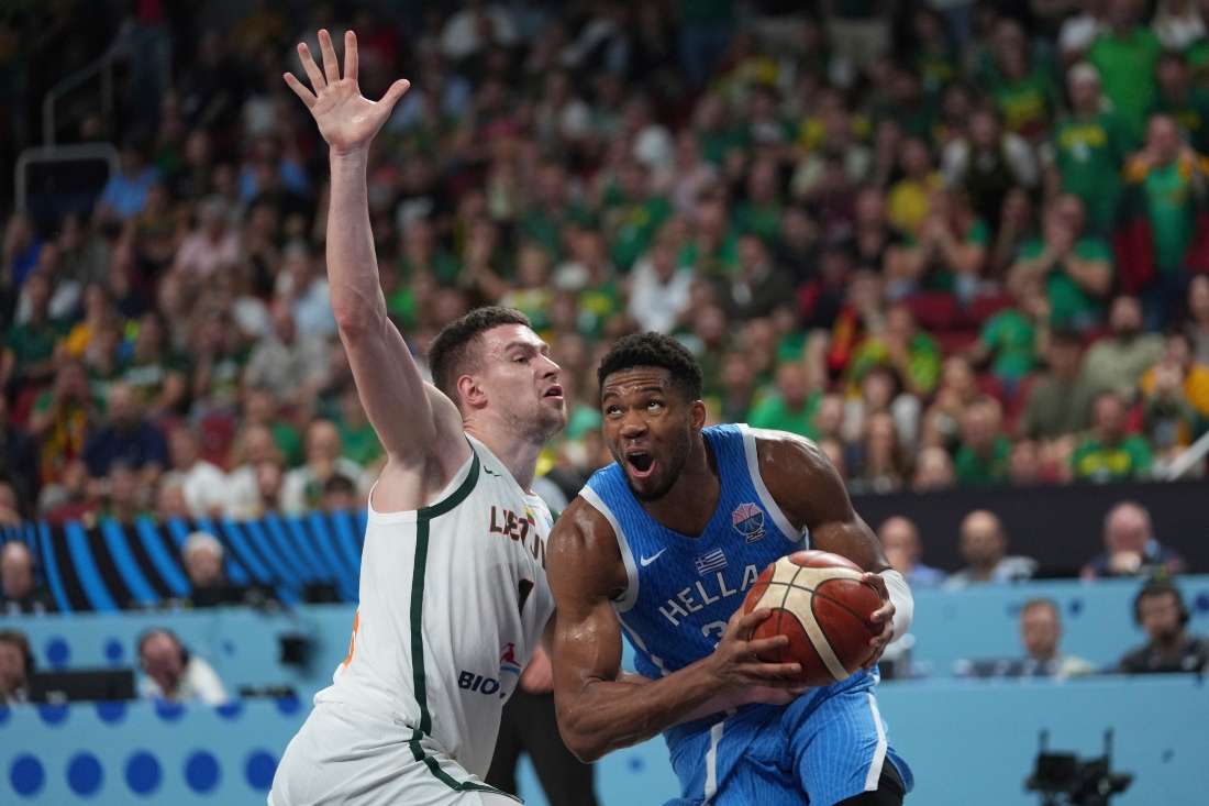Greece’s Giannis Antetokounmpo drives to the basket past Lithuania’s Marek Blazevic during the EuroBasket quarterfinal match between Lithuania and Greece at the Riga Arena in Riga, Latvia, Tuesday. (AP)