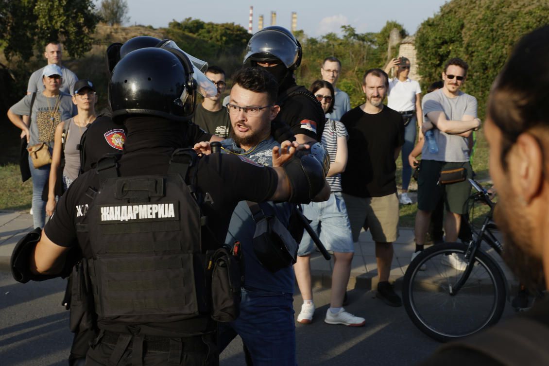 Serbian gendarmerie officers push away an anti-government protester and guard an intersection in Novi Sad, Sept. 13, 2025. (AP)