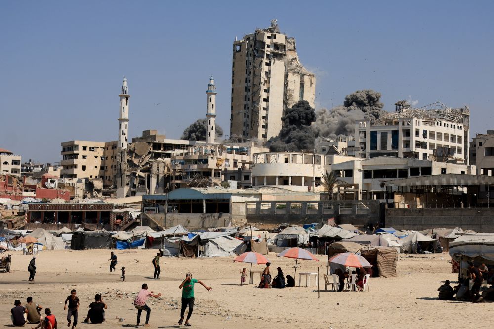 Smoke rises from the evacuated Al-Ghefari residential tower, after it was hit by Israeli air strikes, Gaza City, Sept.15, 2025. (Reuters)