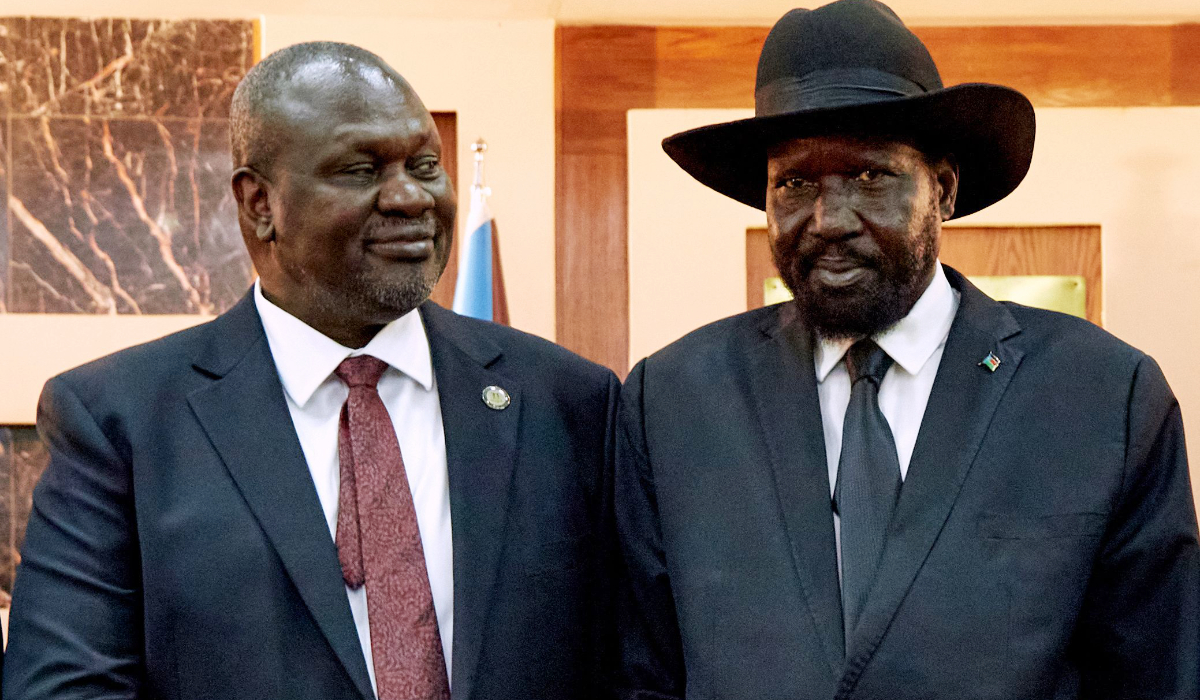 South Sudanese President Salva Kiir (R) shakes hands with First Vice President Riek Machar as he attends his swearing-in ceremony at the State House in Juba,on February 22, 2020, South Sudan. (AFP)