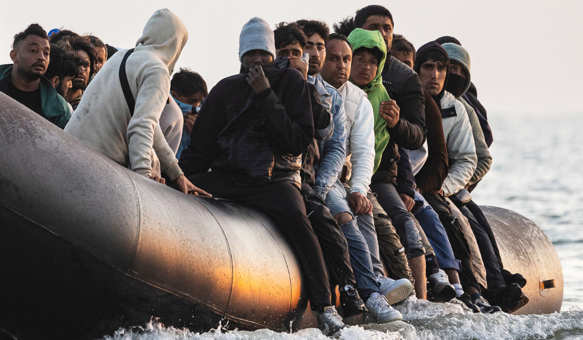 Migrants board a smuggler's inflatable dinghy in an attempt to cross the English Channel off the beach of Gravelines, northern France, on July 29, 2025. (AFP)