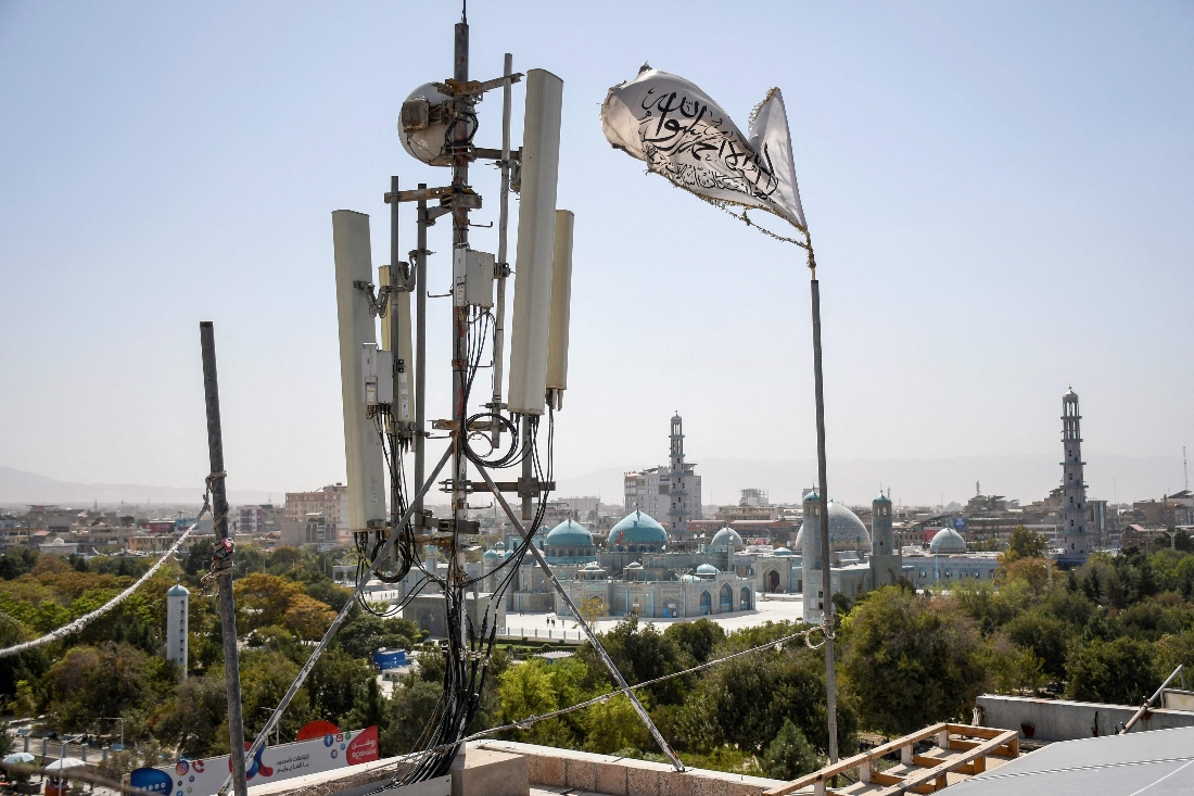 A Taliban flag flutters near telecom equipment installed over a rooftop providing internet services overlooking Hazrat-e-Ali Shrine in Afghanistan. (AFP)