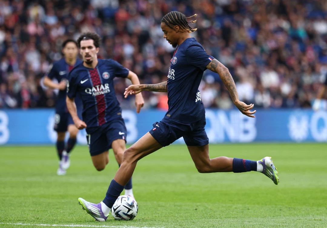 Paris Saint-Germain’s French forward Bradley Barcola shoots and scores the opening goal during their French L1 match against RC Lens at the Parc des Princes stadium in Paris, on Sept. 14, 2025. (AFP)