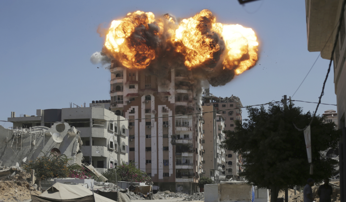 Flames erupt from a building following an Israeli military strike in Gaza City, Sunday, Sept. 14, 2025. (AP)