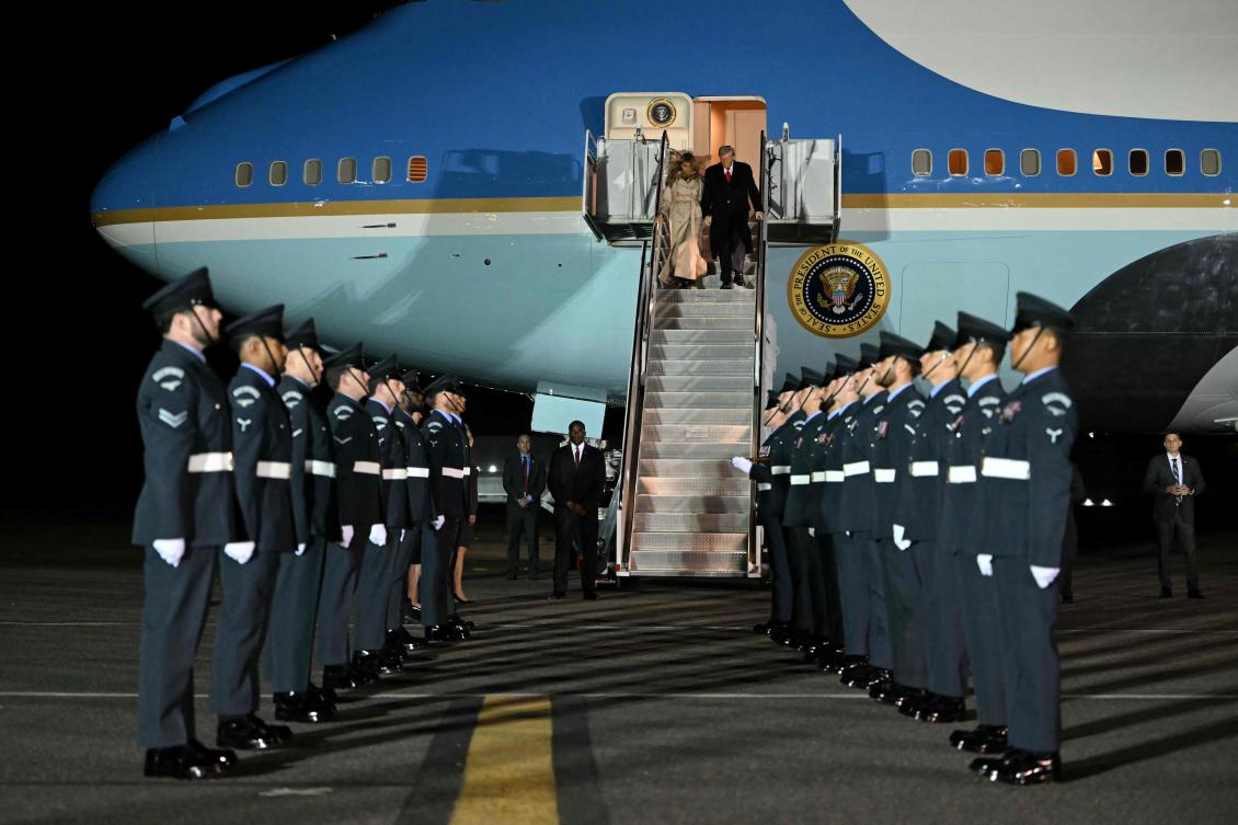 US President Donald Trump and First Lady Melania Trump disembark from Air Force One in Eastern London, UK. (AFP)