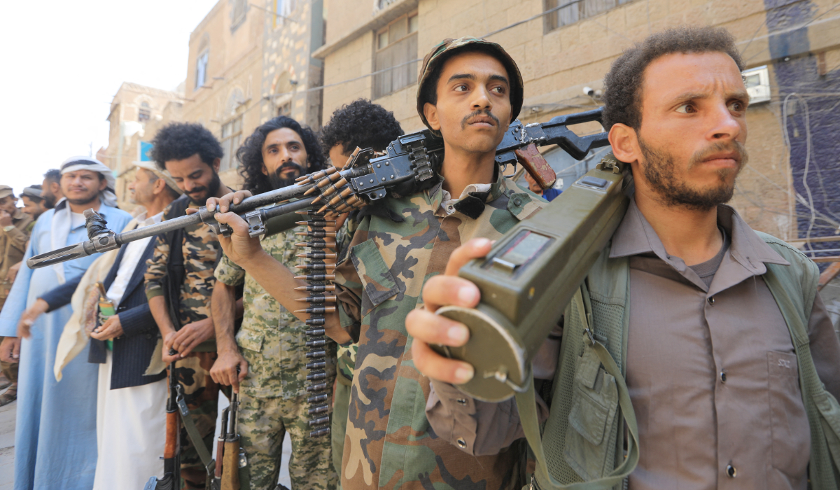 Houthi fighters attend a demonstration near the site of a recent Israeli airstrike, in the Houthi-controlled capital Sanaa on September 13, 2025. (AFP)