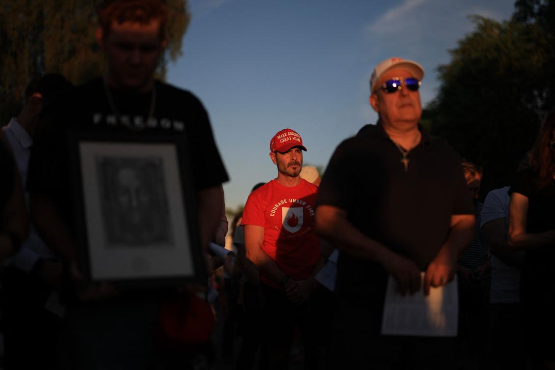 People gather to pray the Rosary during a memorial for Charlie Kirk outside of the headquarters of Turning Point USA on September 16, 2025 in Phoenix, Arizona. (Getty Images via AFP)