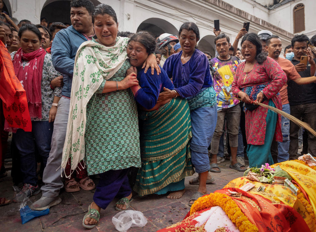 Bhagwati Balami, mother of Subhlal Balami, 28, who died in last week's anti-corruption protests, mourns as she performs last rituals during his cremation at the premises of Pashupatinath temple along the bank of Bagmati river in Kathmandu, Nepal, September 14, 2025. REUTERS/Adnan Abidi