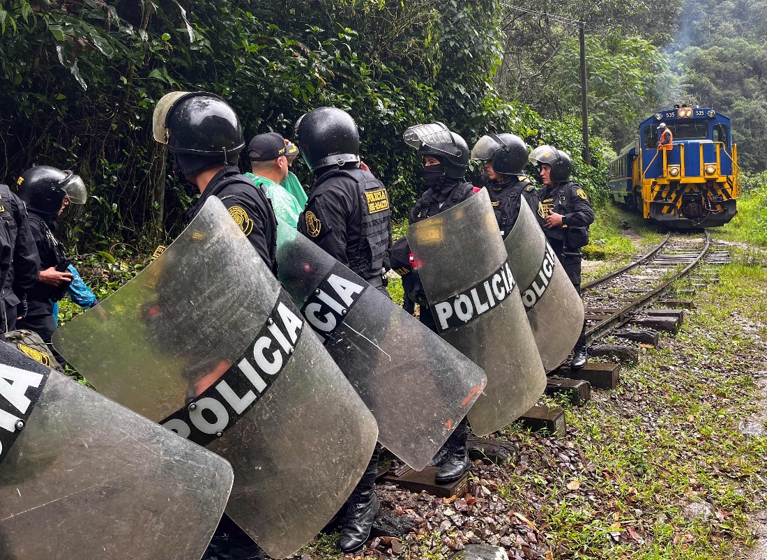Police secure the rail tracks near Machu Picchu Pueblo during a demonstration against the opening of online ticket sales to the Inca citadel in Peru. (AFP)