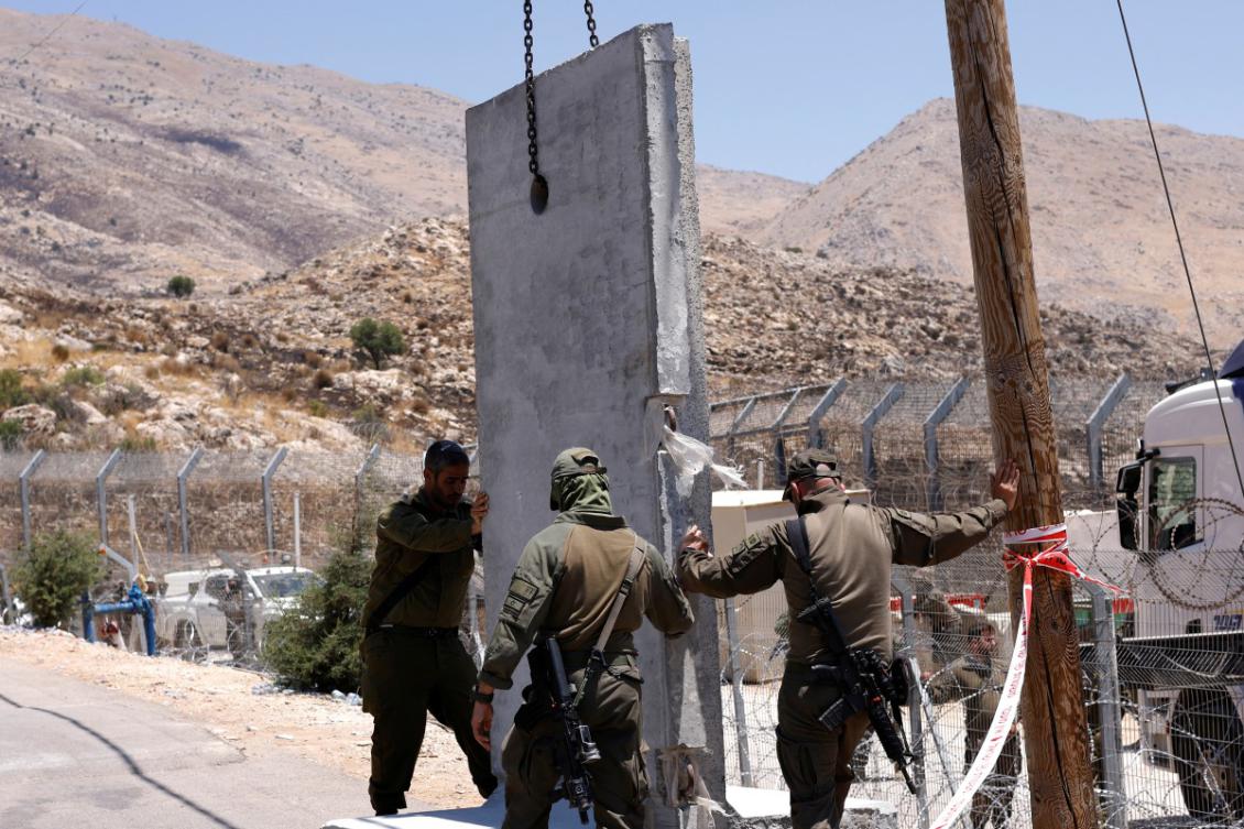 Israeli forces place concrete barriers as they secure the area along the border fence, near the town of Majdal Shams, in the Israeli-annexed Golan Heights, on July 17, 2025. (File/AFP)