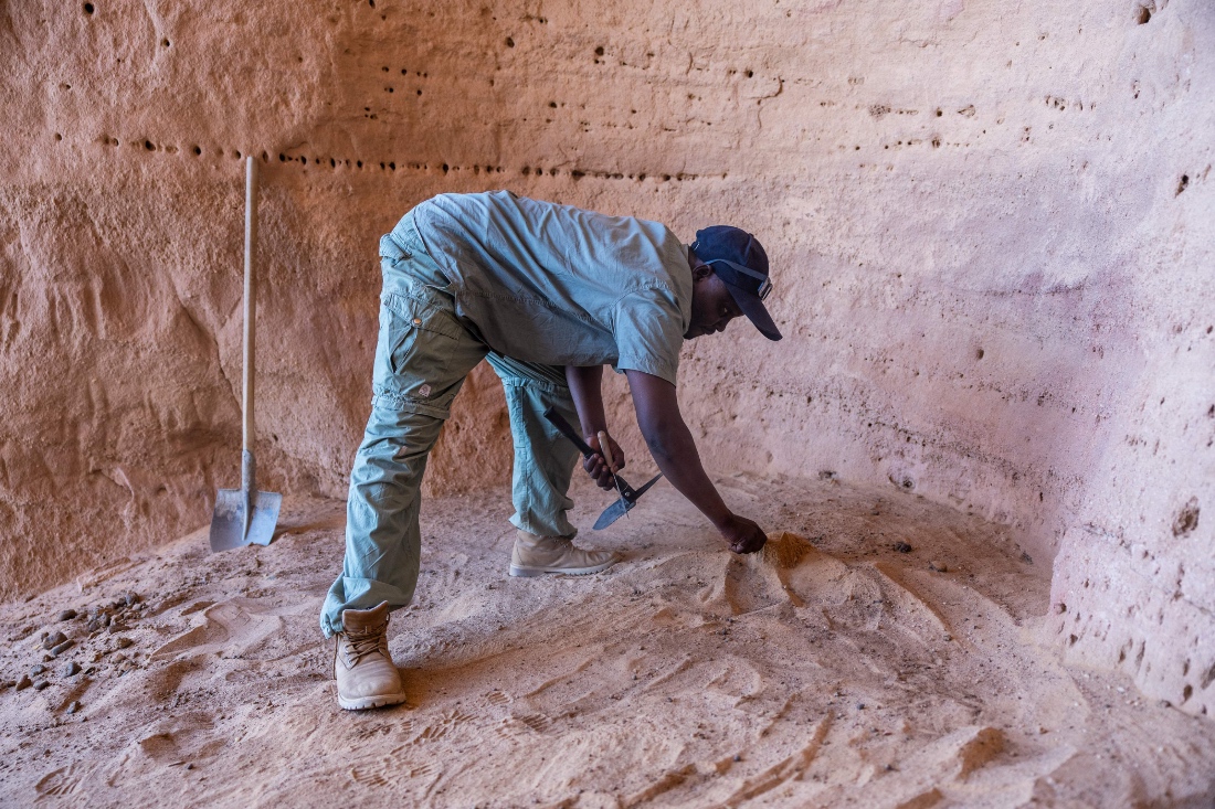Djimet Guemona, 35, an archeologist, clears the area where an archaeological dig will take place at the Garoa Hallagana rock art site, in Ennedi Ouest province, Chad. (AFP)