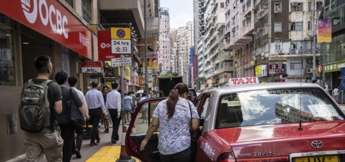 A woman gets into a taxi at the Wan Chai district of Hong Kong. (AFP)