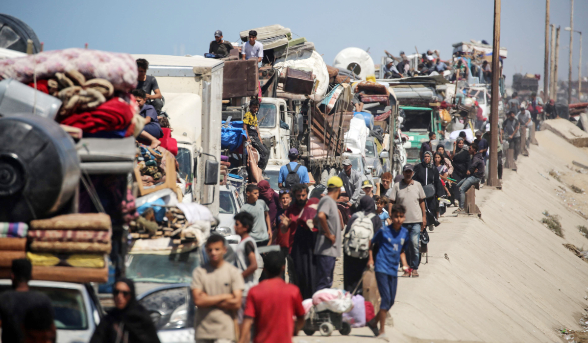 Palestinians from Gaza City move southwards with their belongings, on the coastal road near the Nuseirat refugee camp in the central Gaza Strip, on September 19, 2025. (AFP)