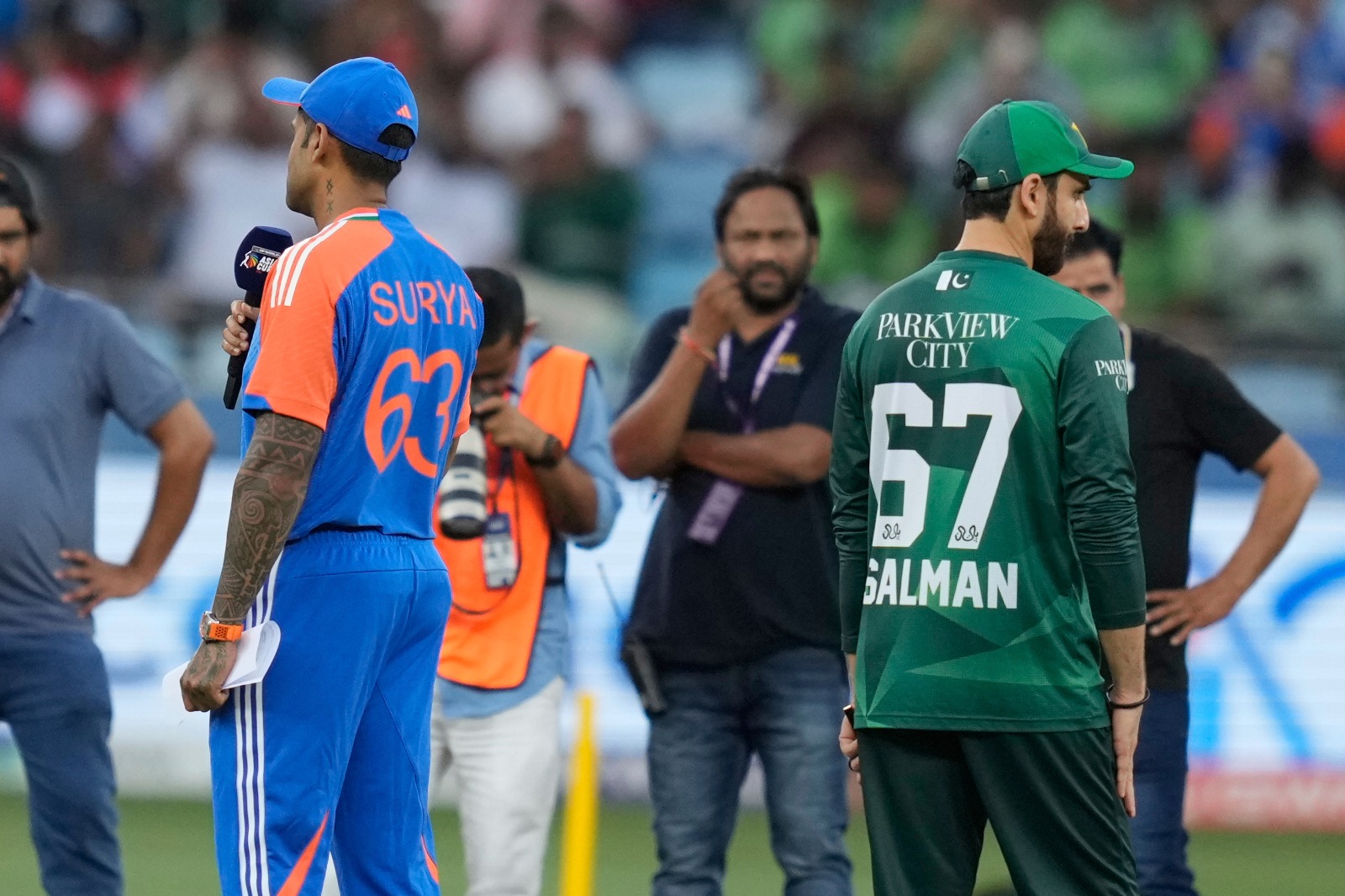 India’s captain Suryakumar Yadav, left, speaks as Pakistan’s captain Salman Agha, right, looks on ahead of the Asia Cup cricket match between India and Pakistan at Dubai International Cricket Stadium in Dubai, United Arab Emirates, Sunday, Sept. 21, 2025. (AP)