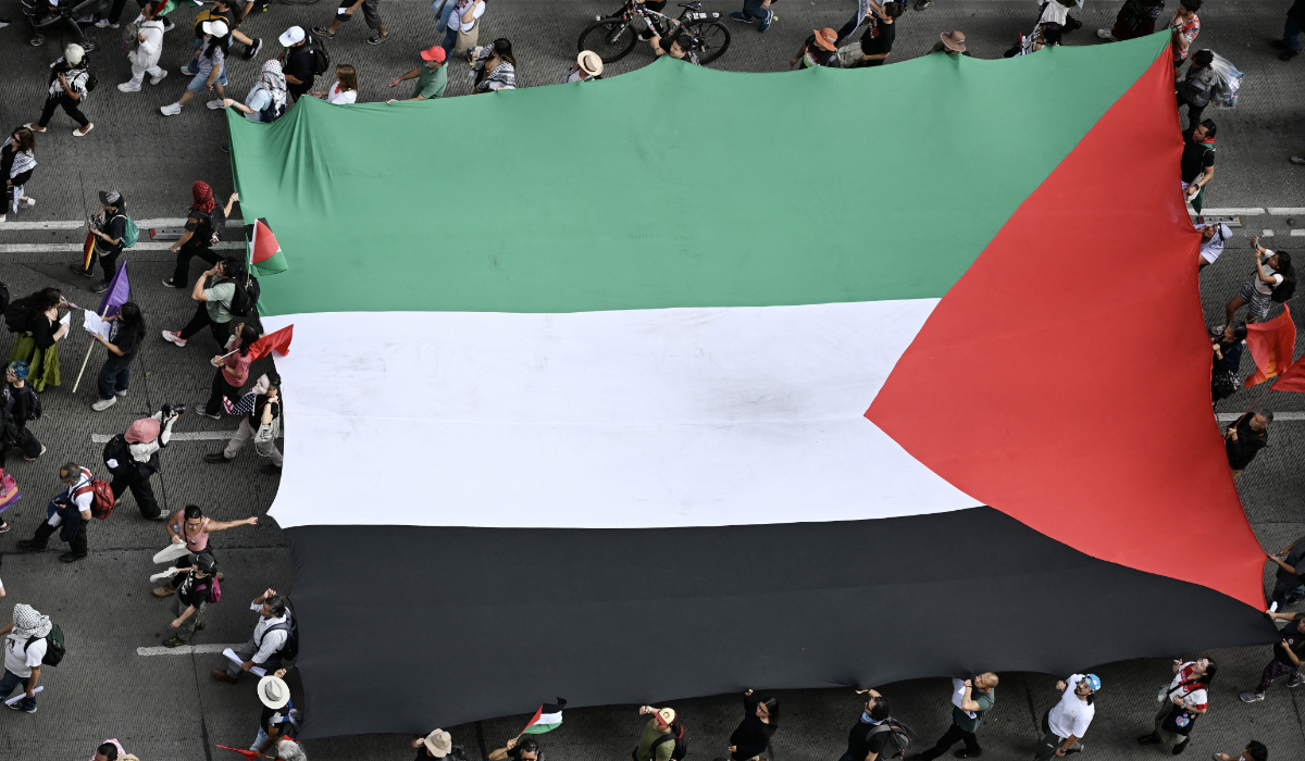 Members of the Global Movement for Palestine wave a giant Palestine flag during a rally against Israel's actions and the ongoing food shortages in the Gaza strip, in Mexico City on August 17, 2025. (AFP)