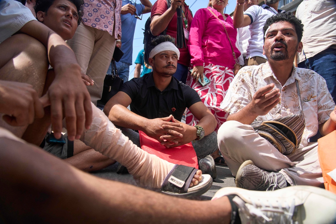 Men injured in the Sept. 8 anti-corruption protest gather outside the Central Administration office to hand over a memorandum demanding treatment for the wounded, proper records of the injured and dead, legal action against those who ordered the firing, in Kathmandu, Nepal. (AP)