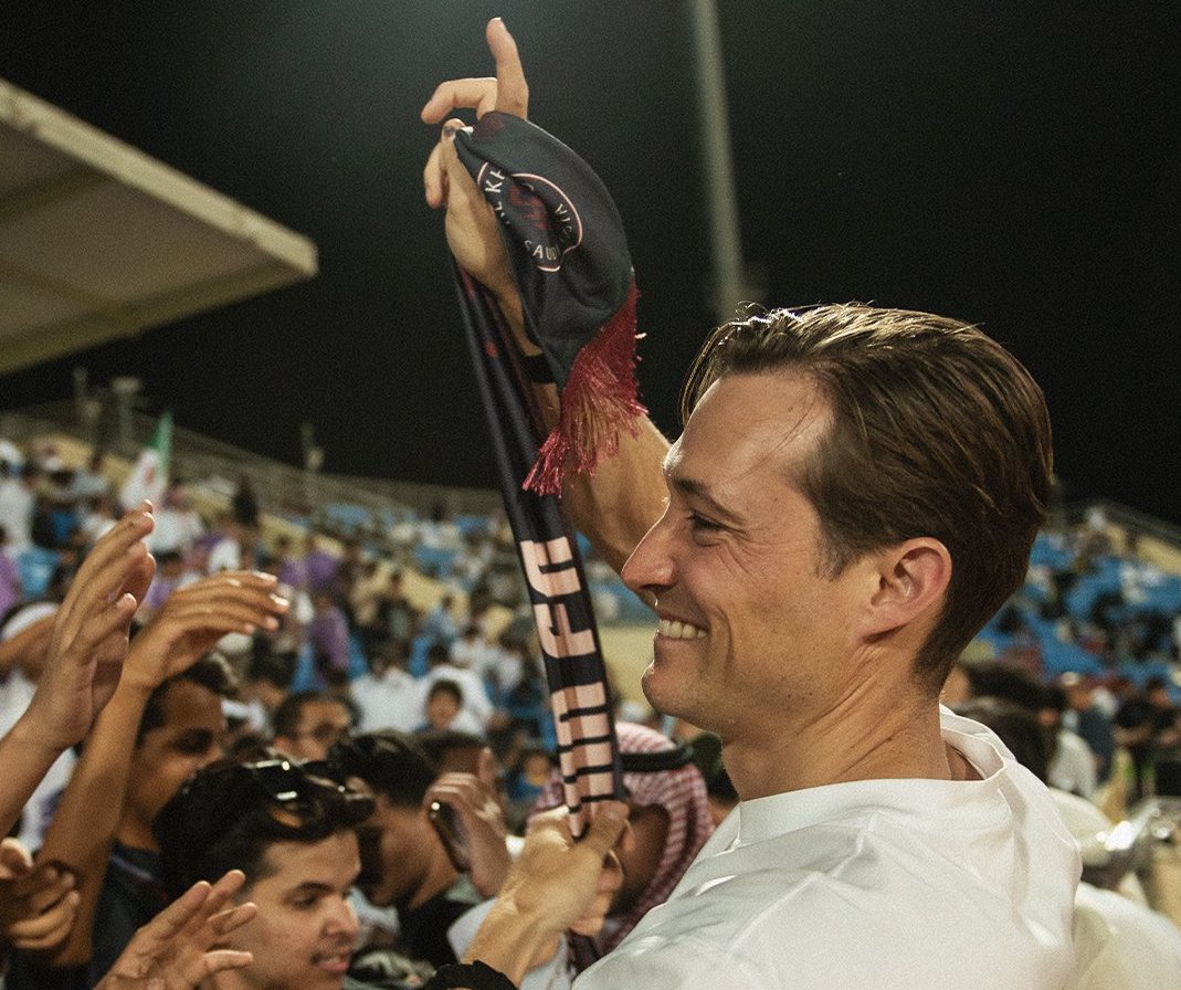 Ben Harburg, seen with Al-Kholood fans, has taken an unusual path into the Kingdom’s sporting landscape by fully acquiring the Saudi Pro League Club. (X: @AlKholoodFC_EN)