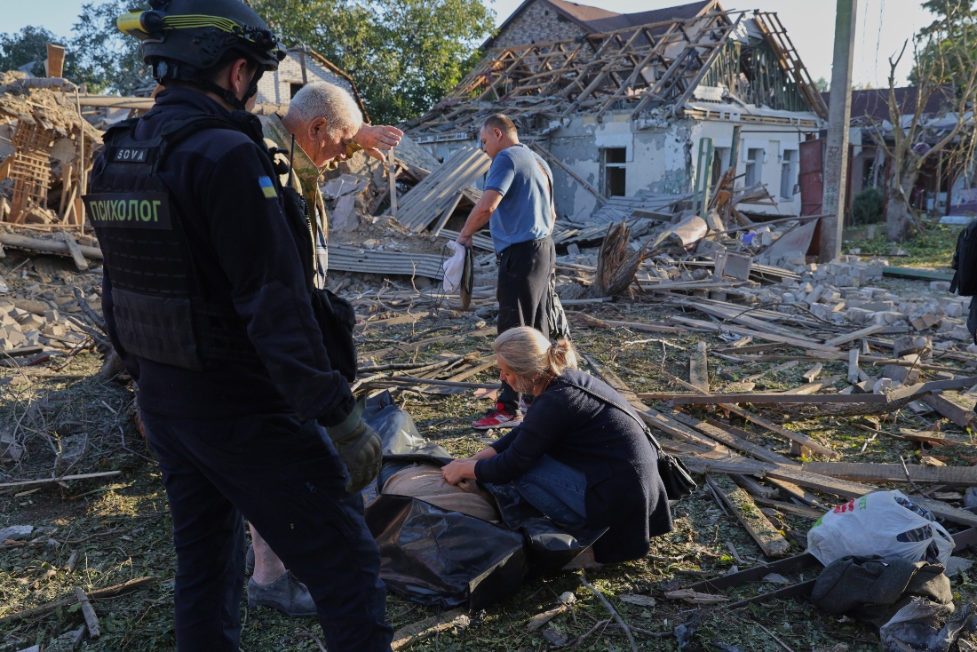 Relatives mourn by a dead body after a Russian strike in Zaporizhzhia, Ukraine. (AP)