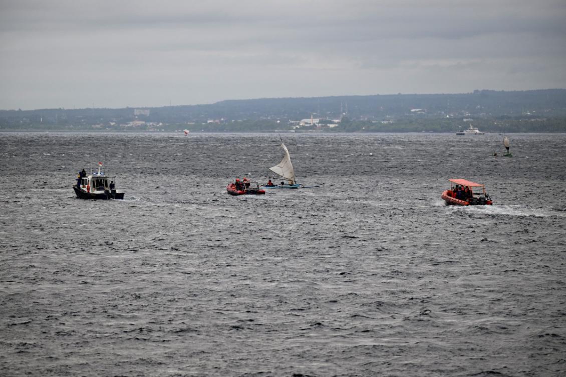 Indonesian rescuers (R and C) and marine police officers search for missing victims of a ferry accident in the waters off the Bali Strait near Jembrana, on Bali island on July 5, 2025. (AFP)