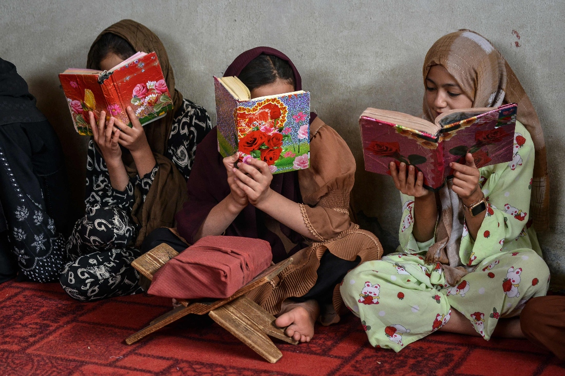 Afghan children read the copies of the holy Koran at a madrassa, or Islamic school, on the outskirts of Fayzabad district in Badakhshan province, Afghanistan. (AFP)