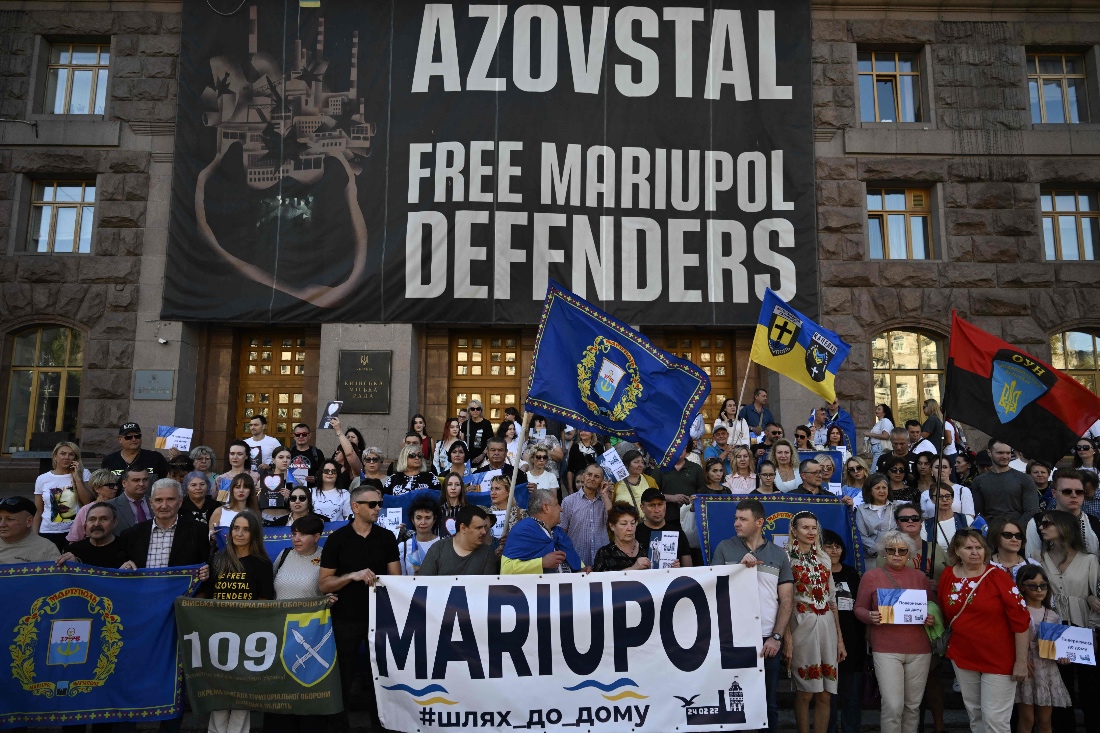 Former residents of Mariupol, who were forced to leave their homes due to the Russian invasion take part in a meeting in central Kyiv, Ukraine. (AFP)